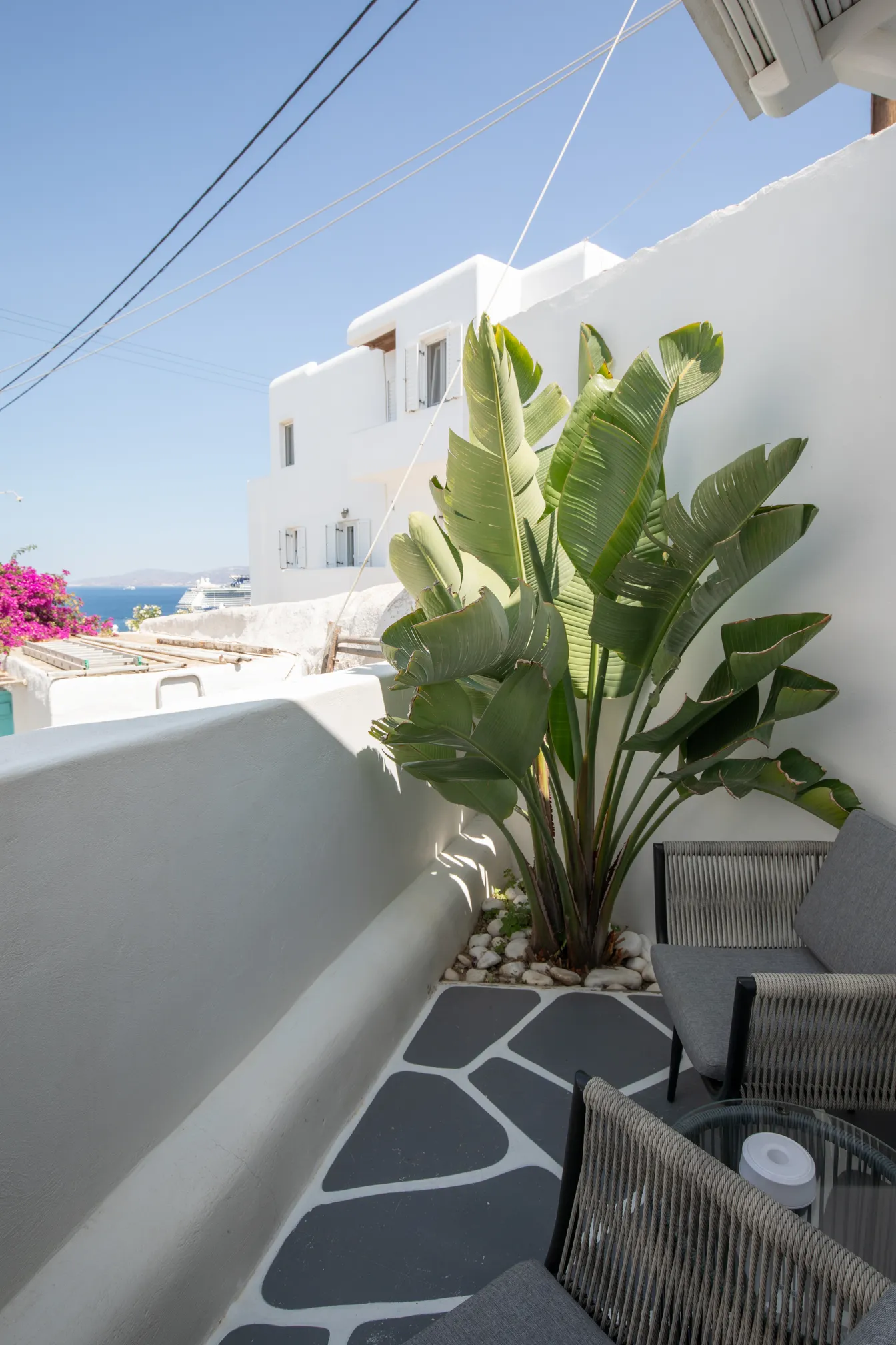 Terrace seating with sea view and white Cycladic walls